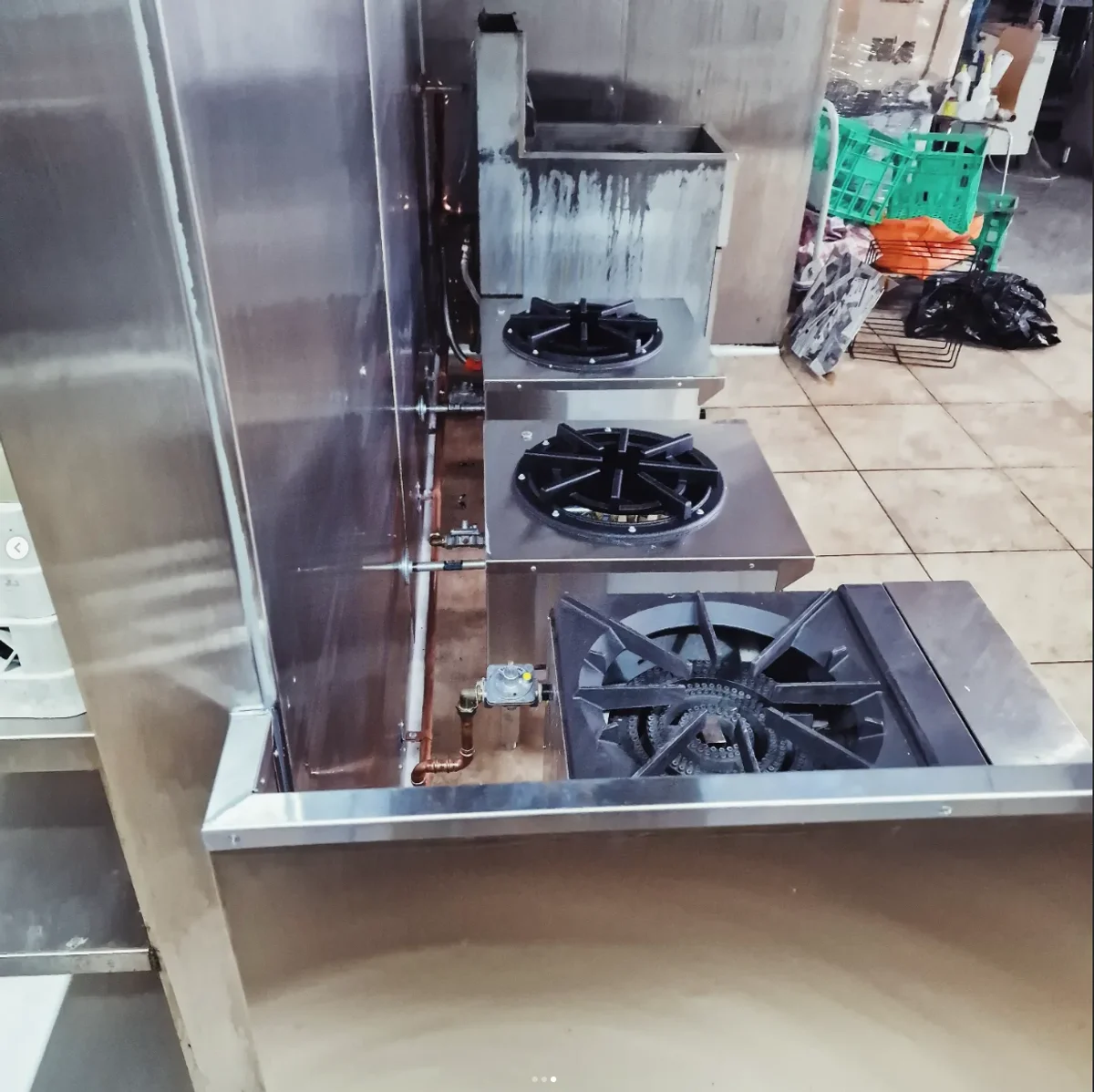 Wok burners and copper gas piping in commercial kitchen